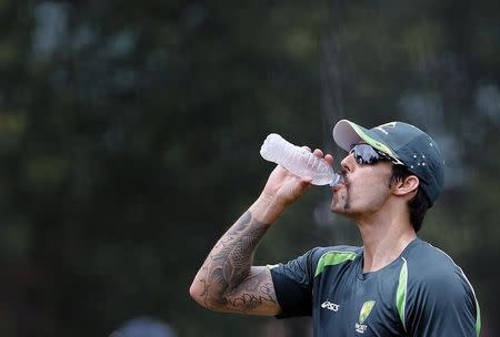 Australia's Mitchell Johnson drinks water during a team training session at the Sydney Cricket Ground January 2, 2014. REUTERS/David Gray/Files