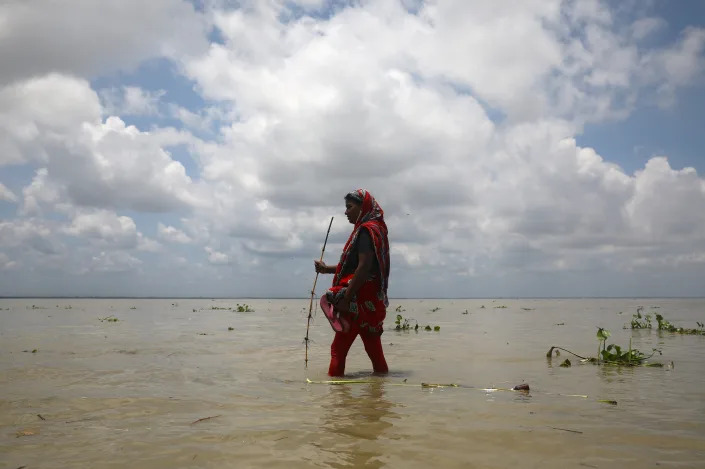 A woman walks in a flooded street