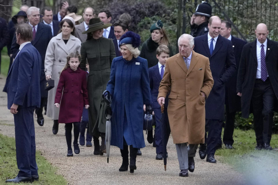 King Charles III, centre, right, and Camilla, the Queen Consort lead the Royal Family as they arrive to attend the Christmas day service at St Mary Magdalene Church in Sandringham in Norfolk, England, Sunday, Dec. 25, 2022. (AP Photo/Kirsty Wigglesworth)