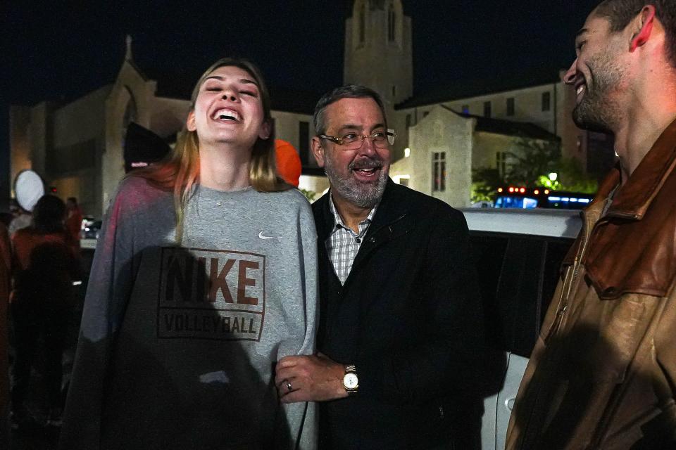 Texas athletic director Chris Del Conte and Longhorns outside hitter Molly Phillips celebrate Sunday night on the UT campus after the win over Nebraska for the national title in Tampa, Fla. The team joined dozens of fans who welcomed the Longhorns home and celebrated with the lighting of the UT Tower.
