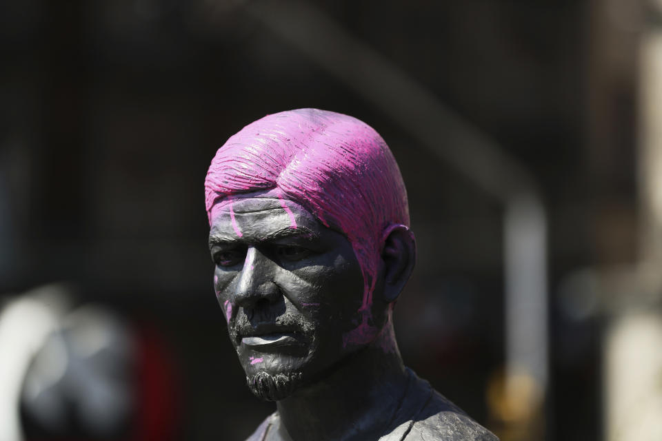 A statue of a man with its hair painted pink stands on a street during the International Women's Day strike "A Day Without Women" in Mexico City, Monday, March 9, 2020. Thousands of women across Mexico went on strike after an unprecedented number of girls and women hit the streets to protest rampant gender violence on International Women's Day. (AP Photo/Fernando Llano)