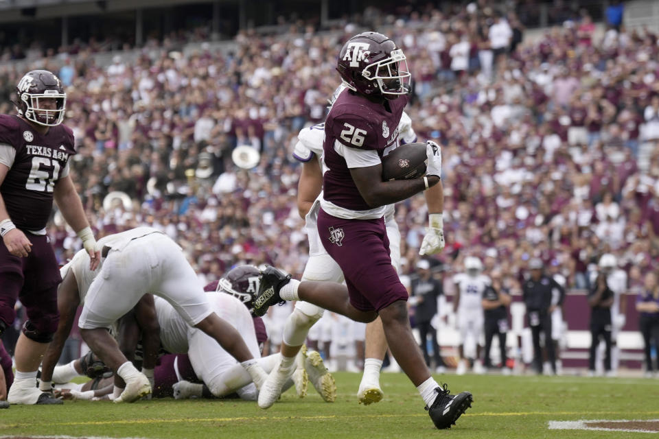 Texas A&M running back David Bailey (26) crosse the goal line for a touchdown against Abilene Christian during the fourth quarter of an NCAA college football game Saturday, Nov. 18, 2023, in College Station, Texas. (AP Photo/Sam Craft)