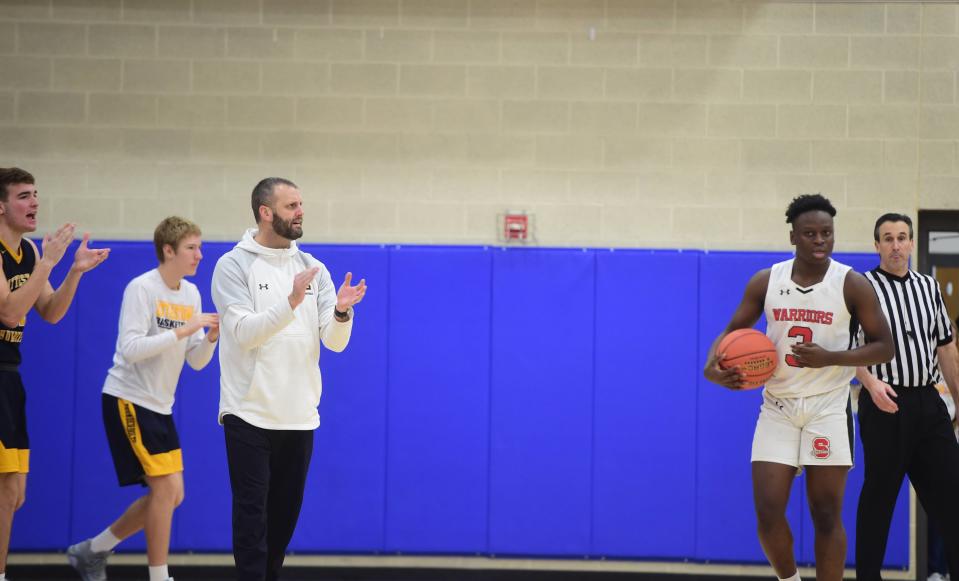 Littlestown head coach Johnathan Forster claps his hands with his team leading at the end of the first half Friday. Susquehannock beat Littlestown, 49-41, at Kennard-Dale's Southern Border Shootout, Friday, Dec. 9, 2022.