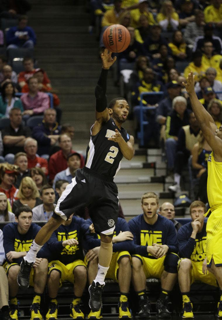 Wofford guard Karl Cochran (2) passes the ball during the first half of a second round NCAA college basketball tournament game against the Michigan Thursday, March 20, 2014, in Milwaukee. (AP Photo/Jeffrey Phelps)