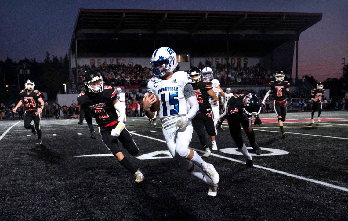 Eatonville quarterback Job Kralik turns the corner in front of Tenino defensive back Keegan O’Connor during Friday night’s 2A football game at Tenino Beaver Stadium in Tenino, Washington, on Sept. 30, 2022.