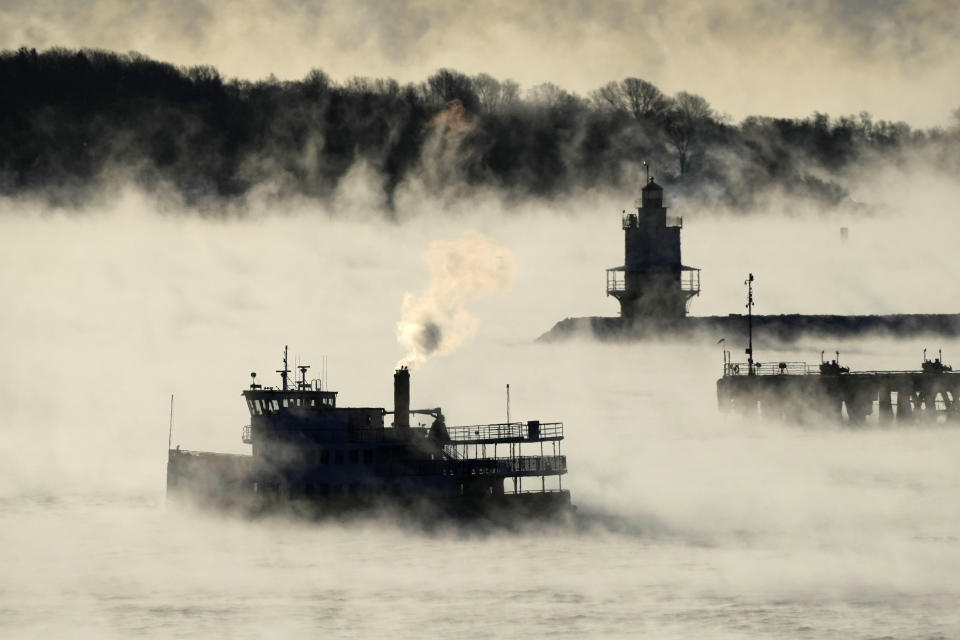 Arctic sea smoke rises from the the Atlantic Ocean as a passenger ferry passes Spring Point Ledge Light, Saturday, Feb. 4, 2023, off the coast of South Portland, Maine. The morning temperature was about -10 degrees Fahrenheit. (AP Photo/Robert F. Bukaty)