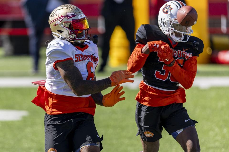 Jan 30, 2024; Mobile, AL, USA; American tight end Jaheim Bell of Florida St (6) and American defensive back Jaylin Simpson of Auburn (36) battle for a pass during practice for the American team at Hancock Whitney Stadium. Mandatory Credit: Vasha Hunt-USA TODAY Sports