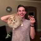 <p>Here Rippon takes a break from figure skating to eat a peanut butter and jelly sandwich and snap a photo with his cat. (Photo via Instagram/adaripp) </p>