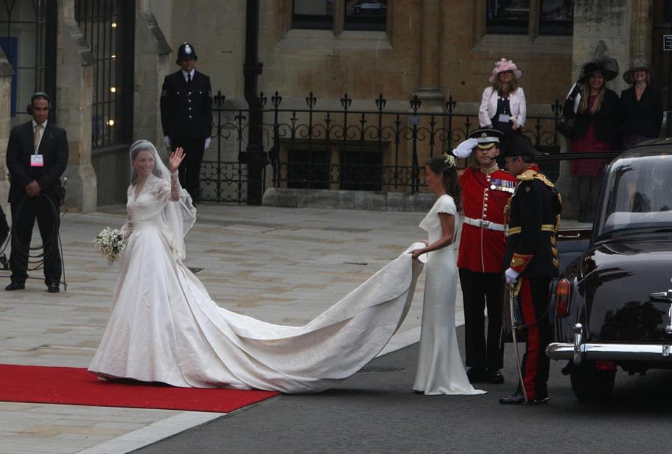 Kate Middleton waves as she arrives at Westminster Abbey where she is helped with her dress by her sister Pippa ahead of her wedding with Prince William (PA Archive)