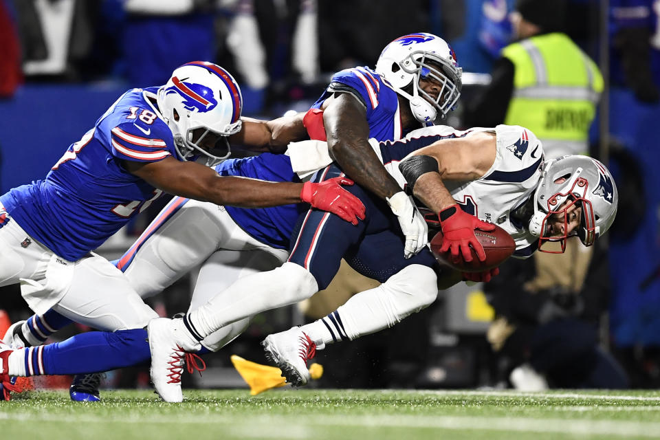 New England Patriots' Julian Edelman, right, collects a punted ball as Buffalo Bills' Andre Holmes, left, and Ramon Humber tackle him down during the second half of an NFL football game, Monday, Oct. 29, 2018, in Orchard Park, N.Y. (AP Photo/Adrian Kraus)