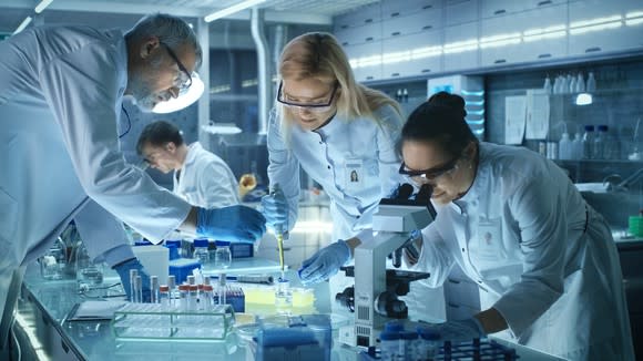 Four scientists working together in a lab.