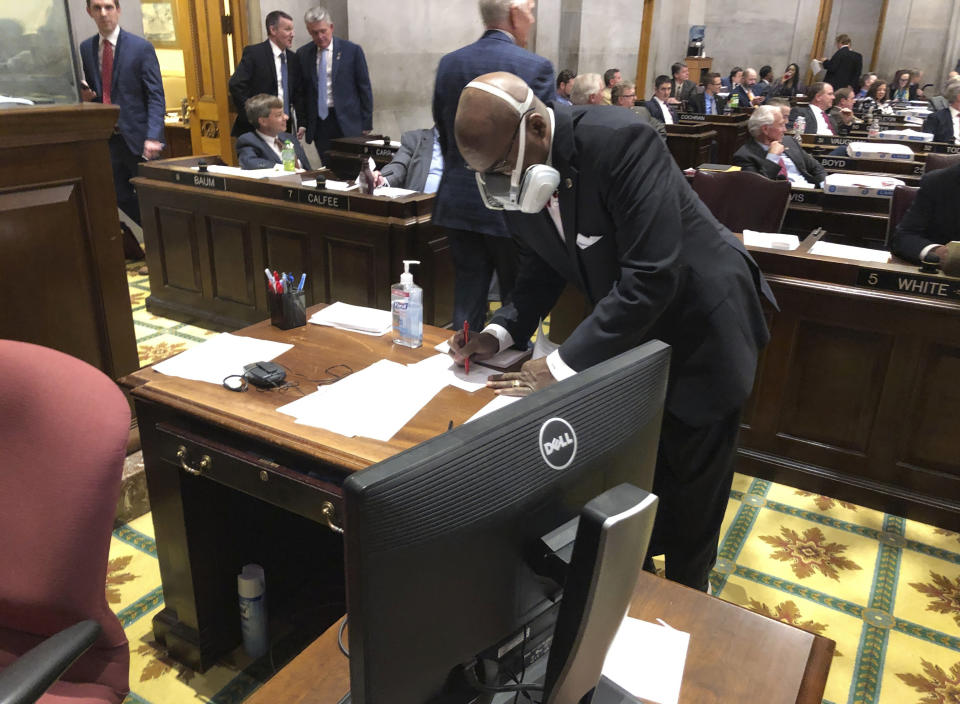 FILE - In this March 19, 2020 file photo State Rep. G.A. Hardaway, D-Memphis, wears a mask during House floor proceedings in Nashville, Tenn., amid the coronavirus pandemic. Sharing information about people who have tested positive or been exposed to COVID-19 with first responders does not violate medical privacy laws, under guidance issued by the U.S. Department of Health and Human Services. That has not quelled skepticism about how the data is used. “Tell us how it’s working for you, then tell us how well it’s been working; don’t just tell us you need it for your job,” said Hardway, a Memphis Democrat who chairs the Tennessee Black Caucus. (AP Photo/Jonathan Mattise, file)