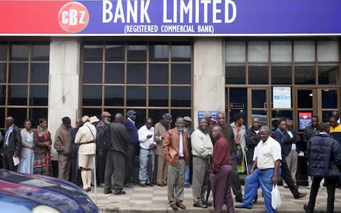 Zimbabweans queue to withdraw money in Harare - Credit: PHILIMON BULAWAYO/Reuters