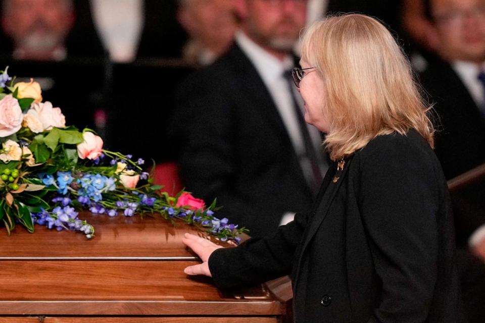 PHOTO: Amy Carter, daughter of former US President Jimmy Carter, touches the casket after speaking during a tribute service for former US First Lady Rosalynn Carter, at Glenn Memorial Church in Atlanta, on Nov. 28, 2023. (Brynn Anderson/POOL/AFP via Getty Images)