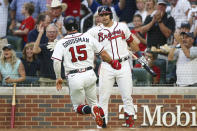 Atlanta Braves' Robbie Grossman (15) celebrates with Austin Riley (27) after scoring a run during the third inning of the team's baseball game against the New York Mets, Thursday, Aug. 18, 2022, in Atlanta. (AP Photo/Brett Davis)