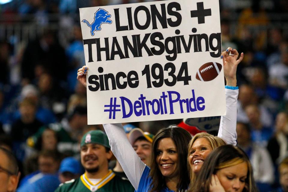 Detroit Lions fan holds a sign for Thanksgiving day during an NFL football game against the Green Bay Packers in Detroit, Thursday, Nov. 24, 2011. (AP Photo/Rick Osentoski)
