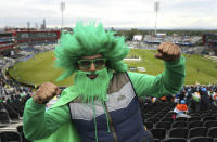 A Pakistan cricket fan poses for a photo in the stands prior to the start of play in the ICC Cricket World Cup group stage match between India and Pakistan, at Emirates Old Trafford stadium in Manchester, England, Sunday June 16, 2019. (Martin Rickett/PA via AP)