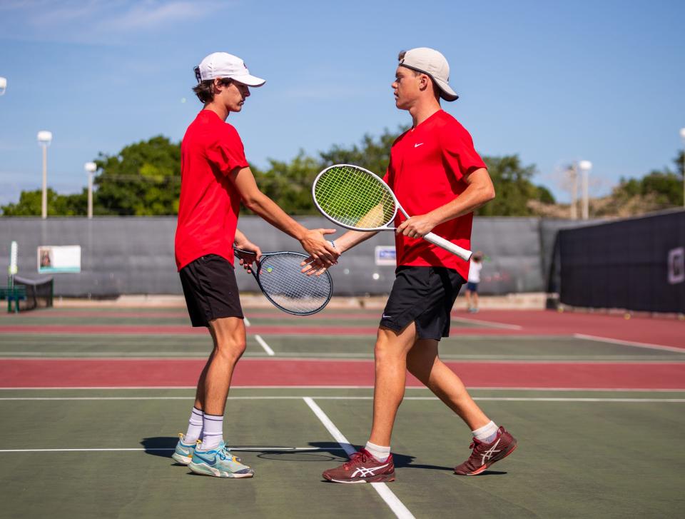 Vero Beach duo Walter Lloyd (left) and Mason Cisco share a victorious handshake following their win over Windermere at the Region 4-4A high school tennis semifinals, on Tuesday, April 23, 2024, at Vero Beach High School.