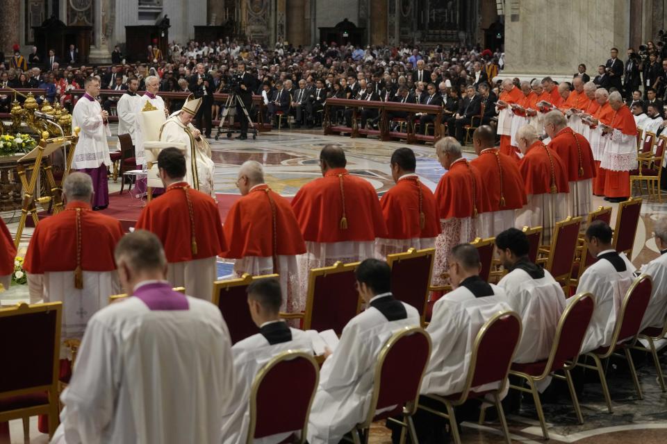 Pope Francis prays in front of new Cardinals during consistory inside St. Peter's Basilica, at the Vatican, Saturday, Aug. 27, 2022. Pope Francis has chosen 20 men to become the Catholic Church's newest cardinals. (AP Photo/Andrew Medichini)