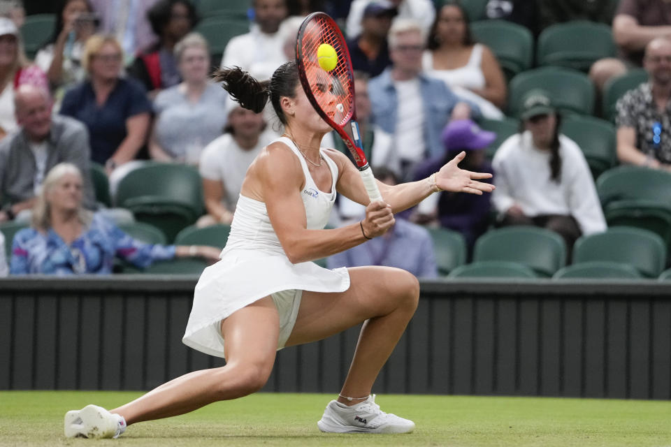 Emma Navarro of the United States plays a forehand return to compatriot Coco Gauff during their fourth round match at the Wimbledon tennis championships in London, Sunday, July 7, 2024. (AP Photo/Alberto Pezzali)