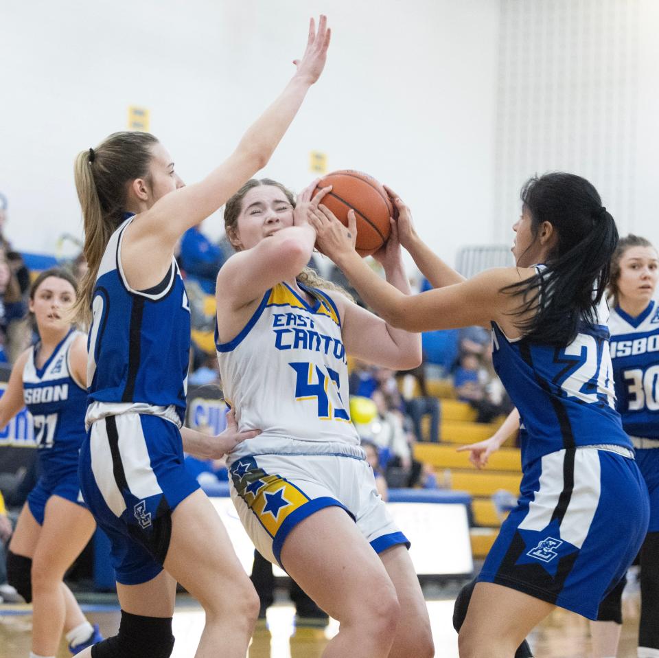 East Canton's Anna Baker is pressured from Lisbon David Anderson's Lyla Brown, left, and Amore Ramos, in the first half at East Canton Thursday, Feb. 15, 2024.