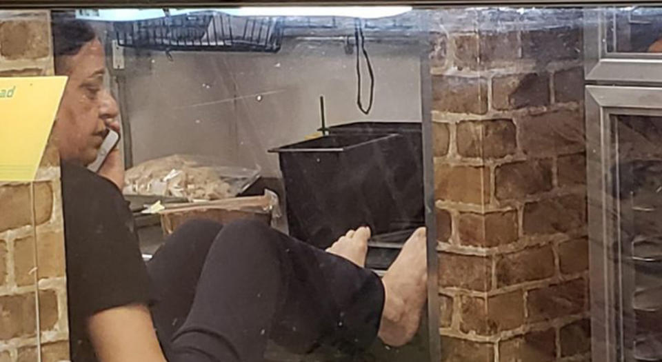 An employee at a Subway restaurant inMichigan, US, caught with her bare feet up on the prep bench. Source: Tata Renee / Facebook