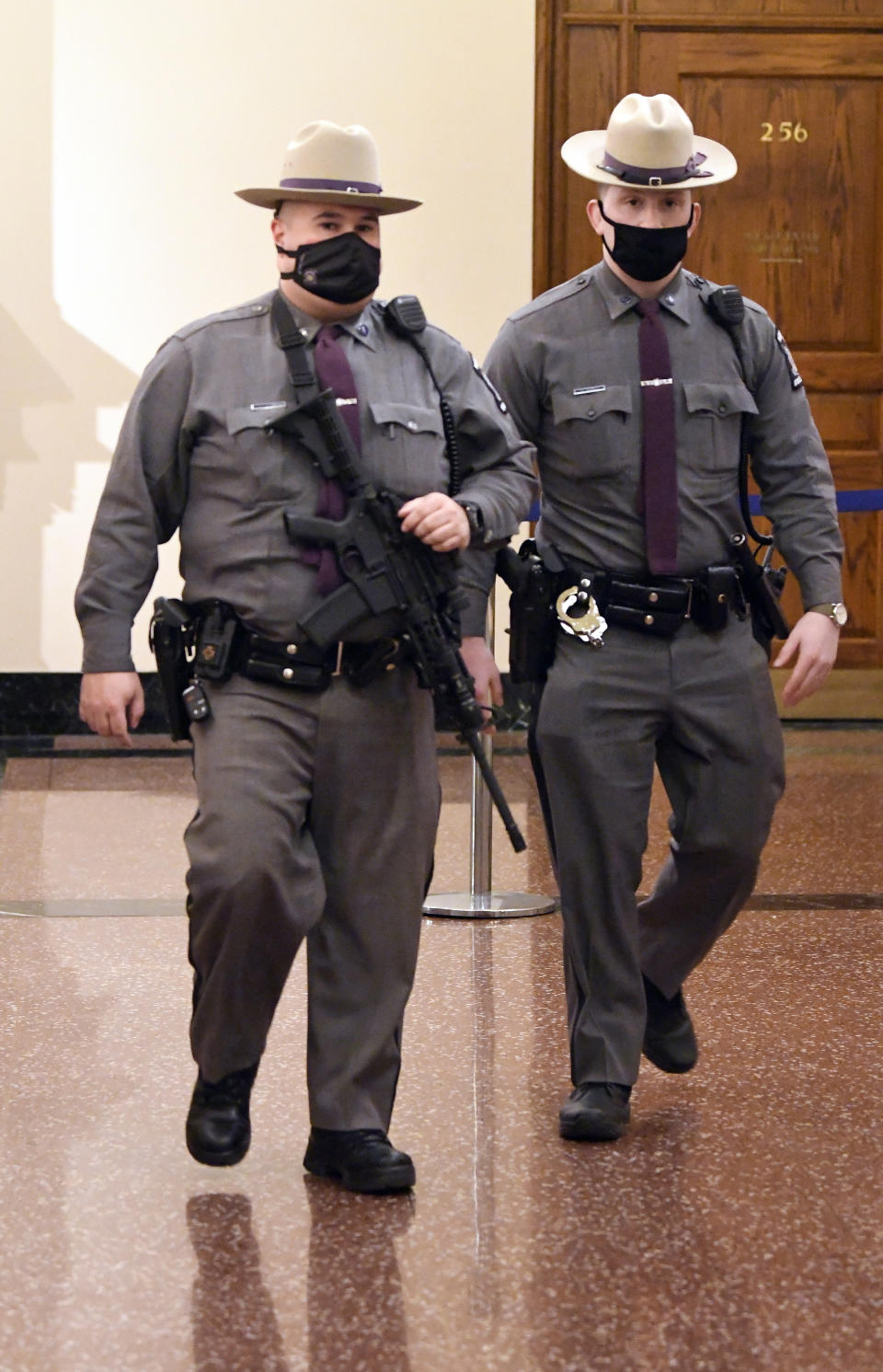 New York state Police patrol the hallways of the state Capitol prior to a planned President Trump protest rally ahead of the inauguration of President-elect Joe Biden and Vice President-elect Kamala Harris Sunday, Jan. 17, 2021, in Albany, N.Y. (AP Photo/Hans Pennink)