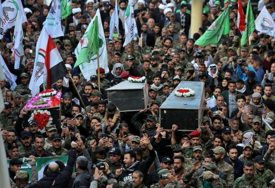 Mourners carry the coffin of Iran-backed Popular Mobilisation fighters killed in the U.S. airstrike in Qaim, during their funeral in Najaf, Iraq.