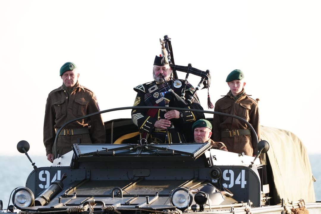 A military piper comes into shore on a DUKW amphibious vehicle ahead of playing a dawn lament on Gold Beach in Arromanches in Normandy, France, to commemorate the 80th anniversary of the D-Day landings. Picture date: Thursday June 6, 2024.