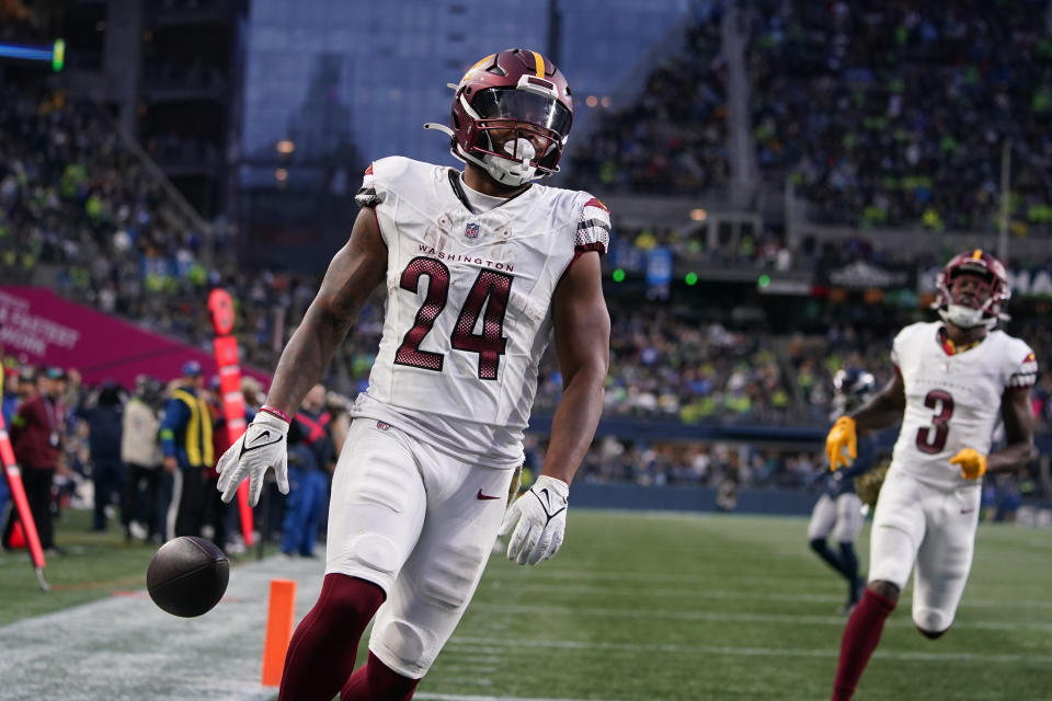 Washington Commanders running back Antonio Gibson (24) scores a touchdown in the second half of an NFL football game against the Seattle Seahawks in Seattle, Sunday, Nov. 12, 2023. (AP Photo/Lindsey Wasson)