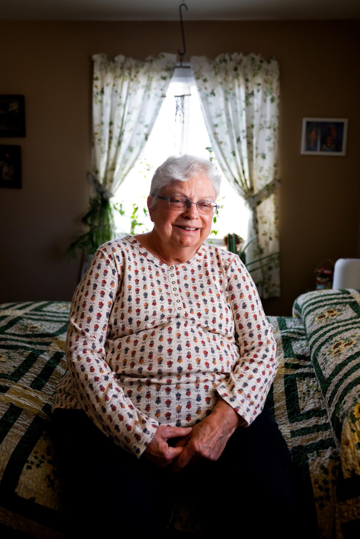Becky Miller sits for a portrait in her bedroom at her Longmont, Colo. home. Miller has been renting a room in her home to Marlene Mears, not pictured, for over two years.