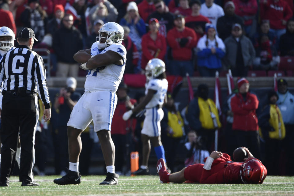 Kentucky defensive lineman Josaih Hayes (97) reacts after sacking Louisville quarterback Jack Plummer (13) during the second half of an NCAA college football game in Louisville, Ky., Saturday, Nov. 25, 2023. Kentucky won 38-31. (AP Photo/Timothy D. Easley)