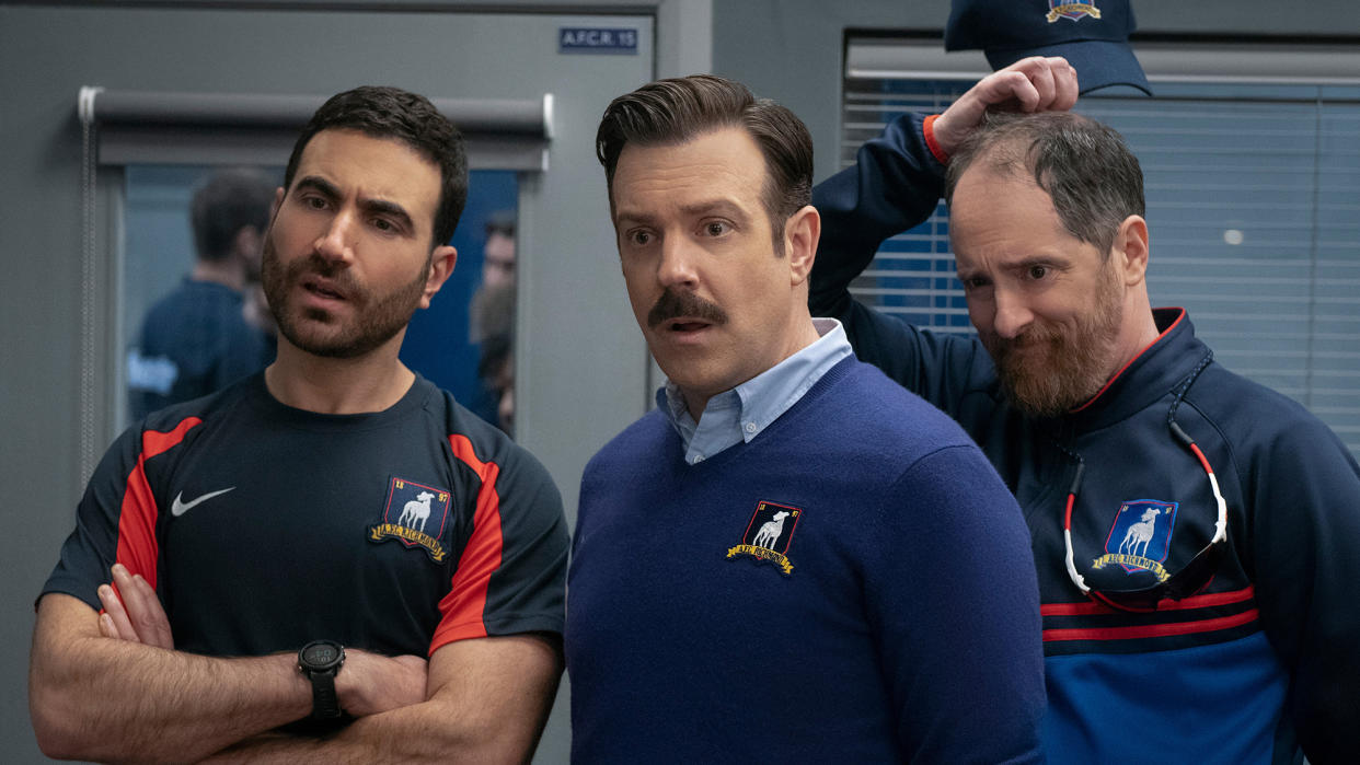  (L to R) Brett Goldstein (as Roy Kent), Jason Sudeikis (as Ted Lasso) and Brendan Hunt (as Coach Beard) in Ted Lasso season 3 