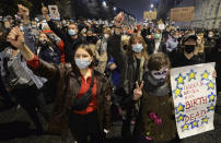 A crowd gathers outside the house of Poland's ruling conservative party leader Jaroslaw Kaczynski in Warsaw, Poland, Friday, Oct. 23, 2020. Protesters vented anger for a second day across Poland over a court ruling that declared abortions of fetuses with congenital defects unconstitutional. The hundreds of protesters who gathered in many cities defied a COVID-19-related ban on gatherings that was imposed nationwide on Friday. (AP Photo/Czarek Sokolowski)