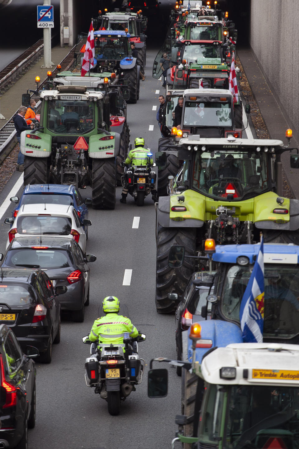 Protesting farmers block a main road leading to the center of The Hague, Netherlands, Wednesday, Oct. 16, 2019. Thousands of Dutch farmers protest over the Netherlands efforts to drastically reduce emissions of greenhouse gases. Among the farmers' demands are that the government does not further reduce the number of animals they can keep. (AP Photo/Peter Dejong)