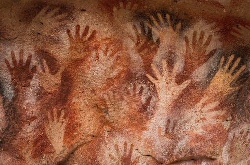 <span class="caption">Prehistoric hand paintings at the Cave of Hands in Argentina, thought to be over 10,000 years old </span> <span class="attribution"><a class="link " href="https://www.shutterstock.com/image-photo/prehistoric-hand-paintings-cave-hands-spanish-1634481835" rel="nofollow noopener" target="_blank" data-ylk="slk:R.M. Nunes/Shutterstock;elm:context_link;itc:0;sec:content-canvas">R.M. Nunes/Shutterstock</a></span>