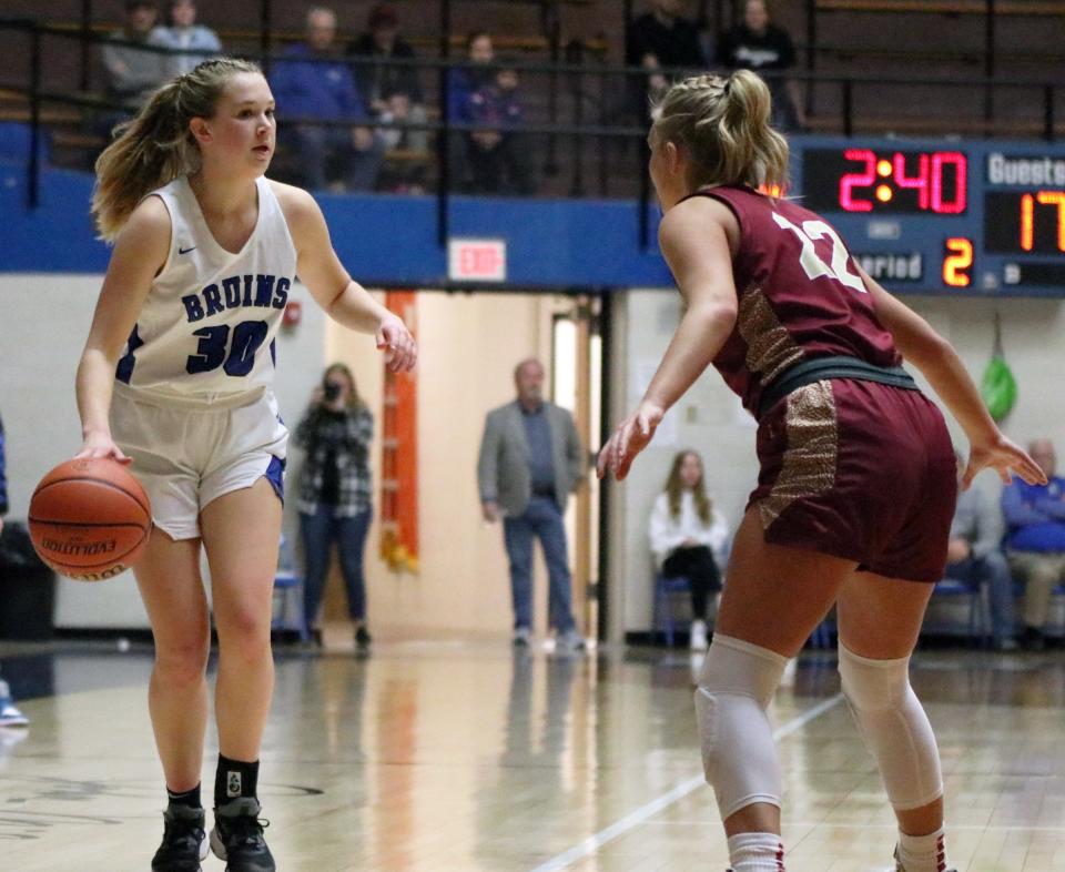 Bethany Christian junior Zoe Willems (30) assesses her options while being defended by Tri junior Rylee Boyd in the second quarter of Saturday's Class 1A North Semi-state championship game at Frankfort High School.