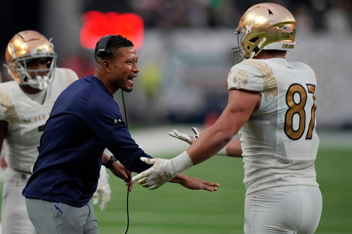 Notre Dame head coach Marcus Freeman, left, celebrates after Notre Dame tight end Michael Mayer (87) made a touchdown catch against BYU during the first half of an NCAA college football game Saturday, Oct. 8, 2022, in Las Vegas. (AP Photo/John Locher) John Locher/AP