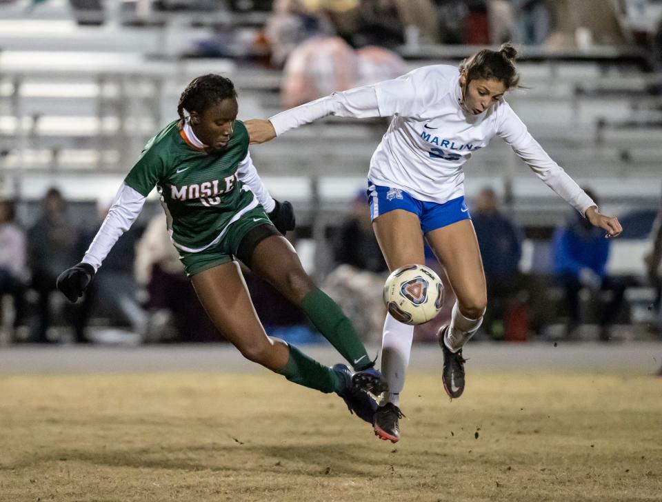 Dolphin Zamiyah Hill and Marlin Lena Dykes get airborne going for the ball. Mosley and Arnold faced off at Gavlak Stadium in the District 2-5A final with the Dolphins coming out on top 2-1 in overtime.