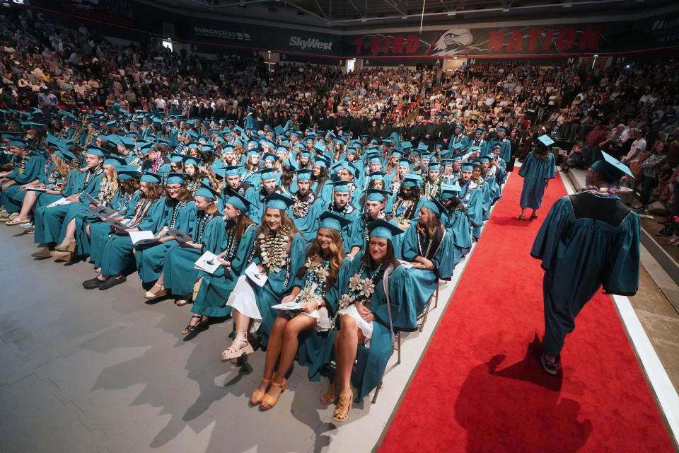 **HOLD AND MOVE WITH STORY**The Canyon View High School graduation is shown Wednesday, May 25, 2022, in Cedar City, Utah. Last year, two school principals in southern Utah's Iron County School District attempted to bar two Native American students from wearing forms of tribal regalia at their graduation ceremonies. One wore it anyway, daring school officials to follow through on the prohibition, while the other reported the incident to the chairwoman of the Paiute Indian Tribe of Utah, who then worked to ensure Native American students had the right to wear tribal regalia at their graduations under state law. (AP Photo/Rick Bowmer)