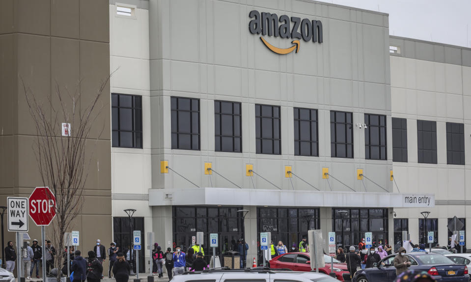 FILE - In this March 30, 2020 file photo, workers at Amazon's fulfillment center in Staten Island, N.Y., gather outside to protest work conditions in the company's warehouse in New York. Amazon is facing a lawsuit from the New York Attorney General’s office that claims the online shopping powerhouse didn’t provide adequate health and safety measures for workers at its New York facilities during the coronavirus pandemic and took retaliatory action against multiple employees. (AP Photo/Bebeto Matthews, File)