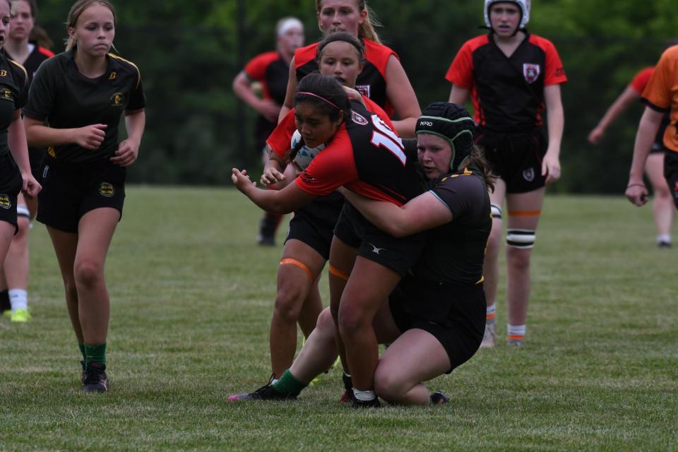 Reaghan King of Smyrna brings down a ball carrier while playing rugby for the Doylestown Dragons.