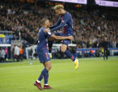 PSG's Kylian Mbappe celebrates with his teammate PSG's Neymar after scoring his side's fourth goal during the French League One soccer match between Paris-Saint-Germain and Lyon at the Parc des Princes stadium in Paris, France, Sunday, Oct. 7, 2018. (AP Photo/Michel Euler)