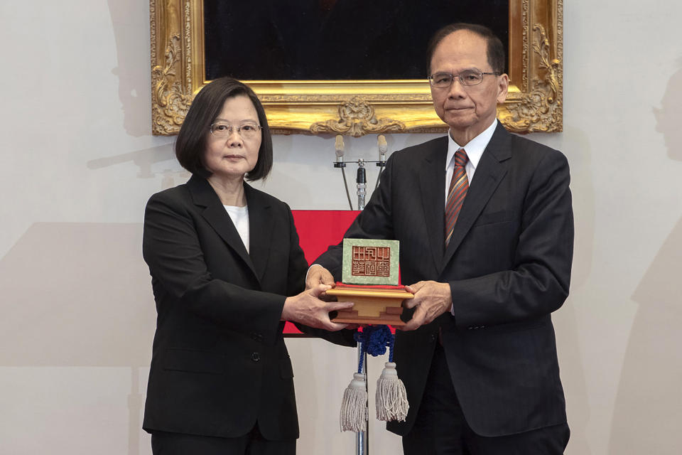 In this photo released by the Taiwan Presidential Office, Taiwanese President Tsai Ing-wen, left, holds up a seal with Parliament top speaker You Shi-kun during an inauguration ceremony at the Presidential office in Taipei, Taiwan on Wednesday, May 20, 2020. Tsai has been inaugurated for a second term amid increasing pressure from China on the self-governing island democracy it claims as its own territory. (Taiwan Presidential Office via AP)