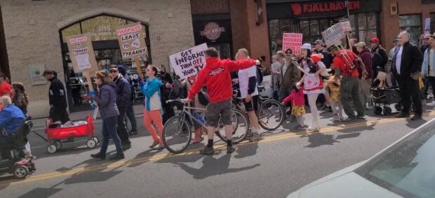 The Pawlowskis and other members of their church have been frequent participants at anti-mask rallies in Calgary. In this photo, from an anti-health restrictions protest on May 2, one of the church attendees can be seen wearing a fake nurses costume covered in dolls representing dead babies. 