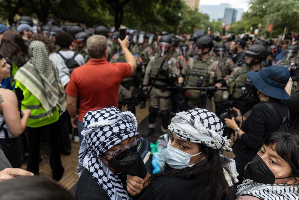 Protesters gather near a police line during a student demonstration in support of Palestine on the University of Texas campus Wednesday, April 24, 2024, in Austin.