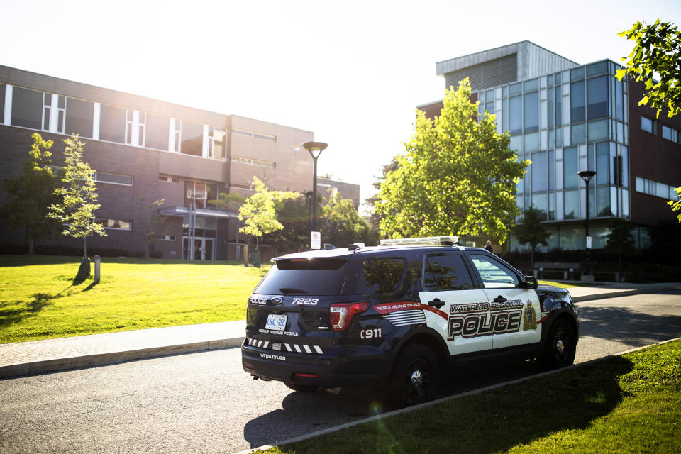 A Waterloo Regional Police vehicle is parked near the scene of a stabbing at the University of Waterloo, in Waterloo, Ontario, Wednesday, June 28, 2023. Police said three victims were stabbed inside the university's Hagey Hall, and a person was taken into custody. (Nick Iwanyshyn/The Canadian Press via AP)