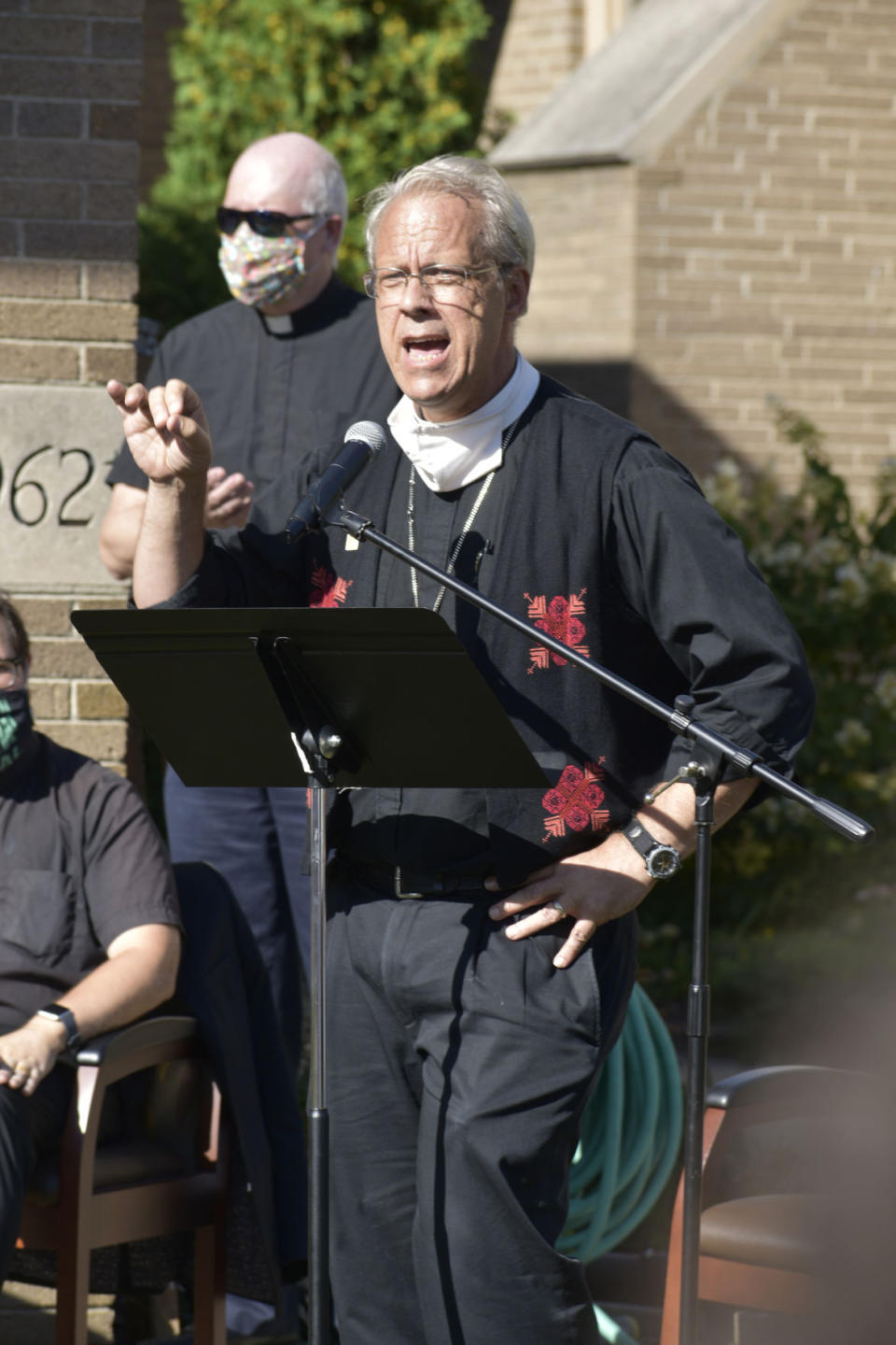 Greater Milwaukee Synod Bishop Paul Erickson addresses the crowd in front of Grace Lutheran Church in Kenosha, Wis., during a service Wednesday, Sept. 2, 2020, in response to the previous week's police shooting of Jacob Blake. Erickson denounced racism as “that toxic poison that is harming us all.” (Dan Truttschel/The Kenosha News via AP)