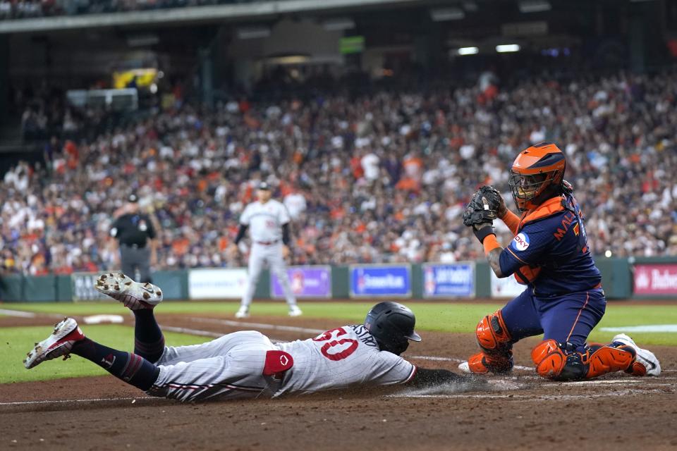 Minnesota Twins' Willi Castro (50) scores as Houston Astros catcher Martin Maldonado reaches to tag him during the fourth inning of a baseball game Monday, May 29, 2023, in Houston. (AP Photo/David J. Phillip)