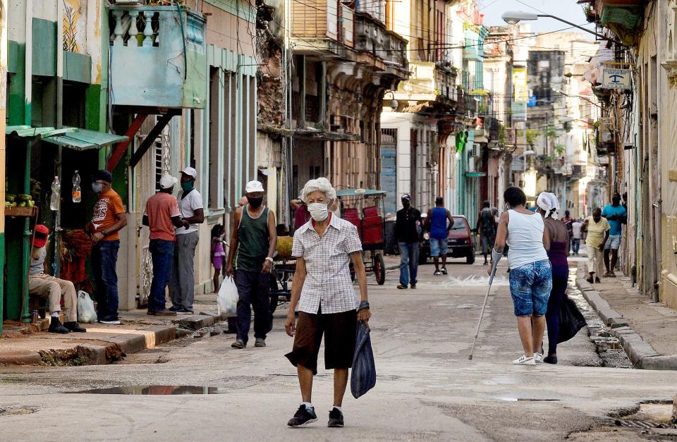 Image:  An elderly person wearing a mask walks along a street of Havana, on April 6, 2021. (Yamil Lage / AFP - Getty Images)